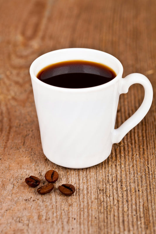 A cup of coffee sitting on top of a wooden table