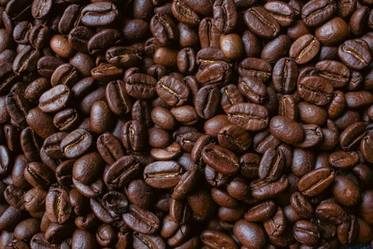Roasted coffee beans fill the frame.
