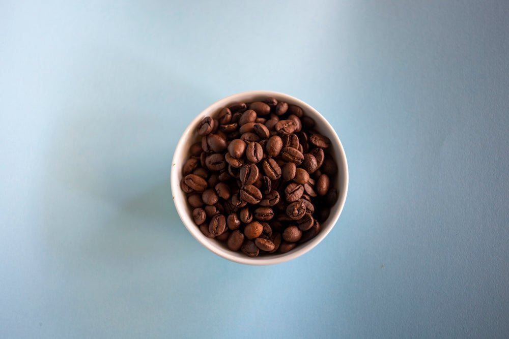 white ceramic mug with coffee beans