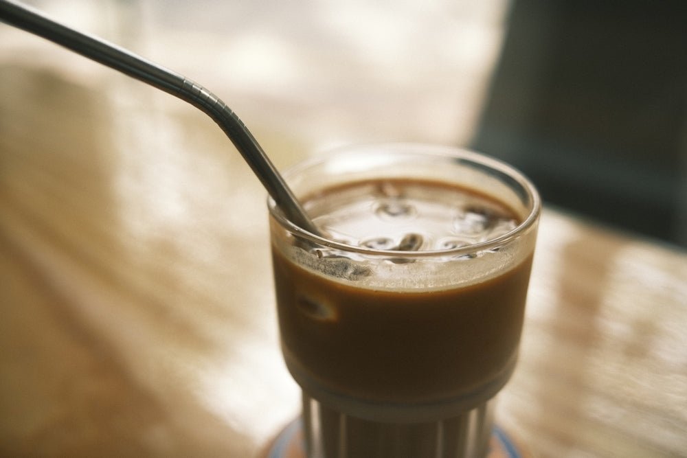 clear drinking glass with brown liquid