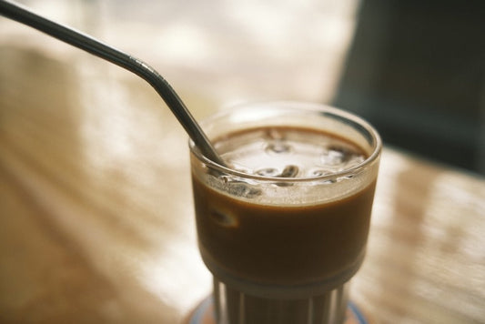 clear drinking glass with brown liquid