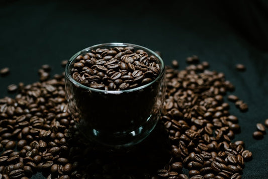 black ceramic mug on brown coffee beans