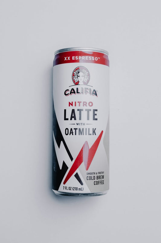 white and red can on white surface