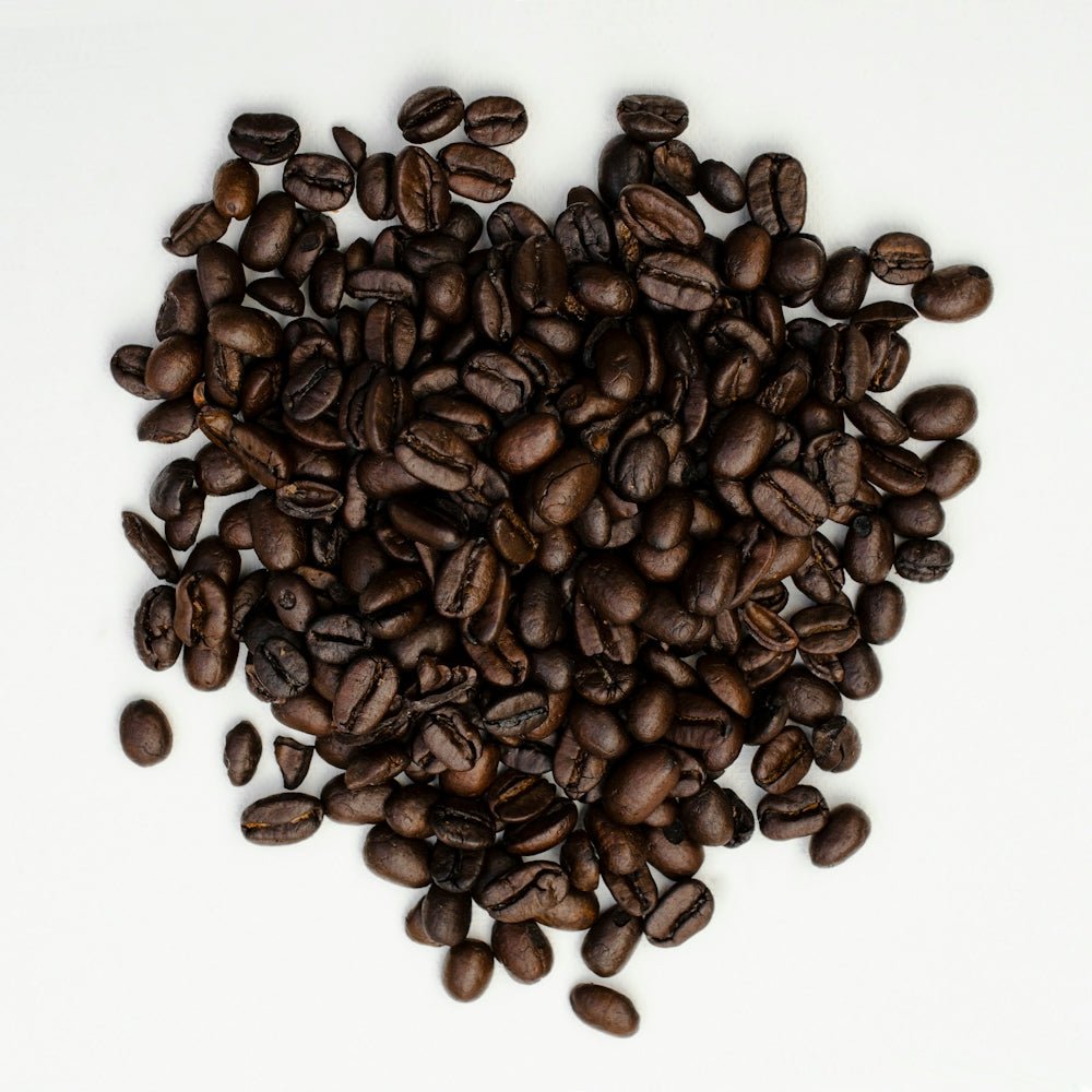 brown coffee beans on white surface
