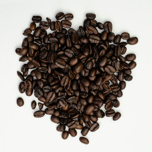 brown coffee beans on white surface