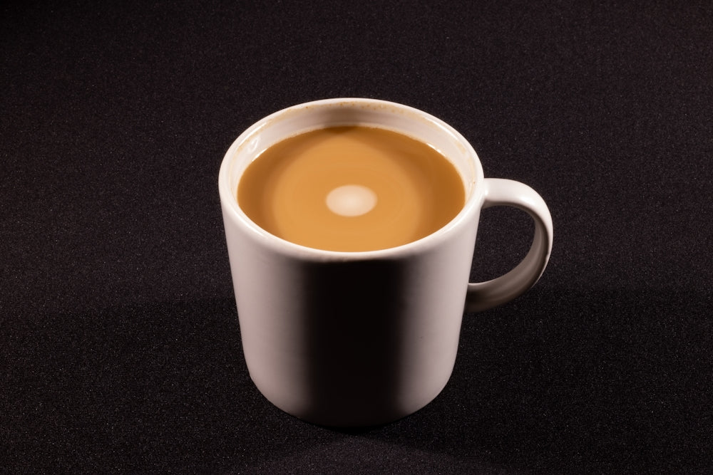 a cup of coffee sitting on top of a table