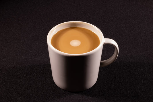 a cup of coffee sitting on top of a table