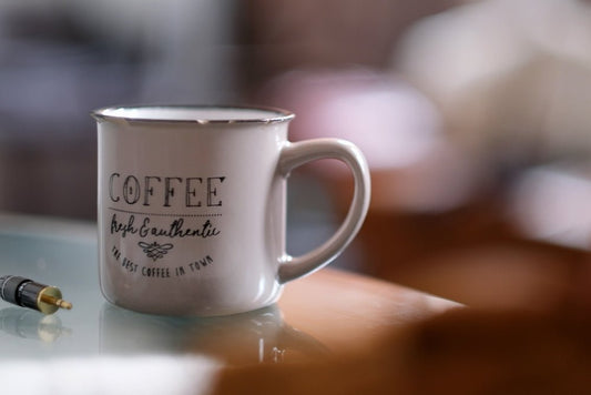 a coffee cup with a bullet on the side of it
