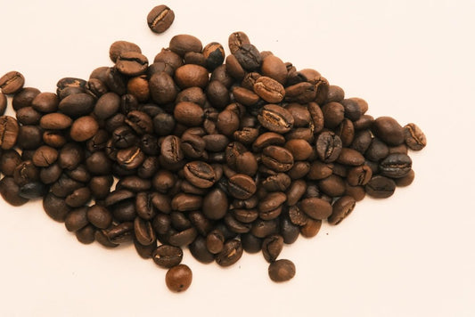 A pile of coffee beans on a white background