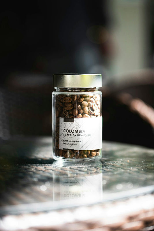 A jar of colombian coffee beans.
